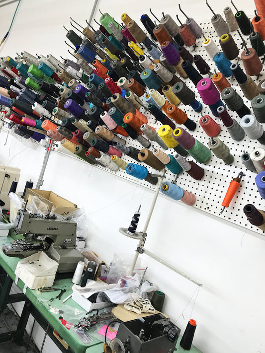 Made in New York - spools of thread on the wall of an NYC sample room