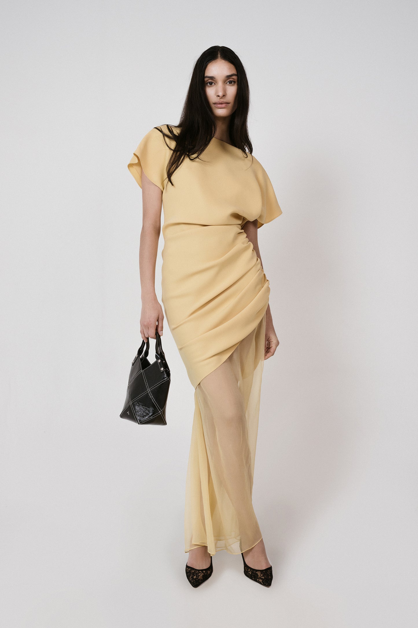 yellow dress with black bag