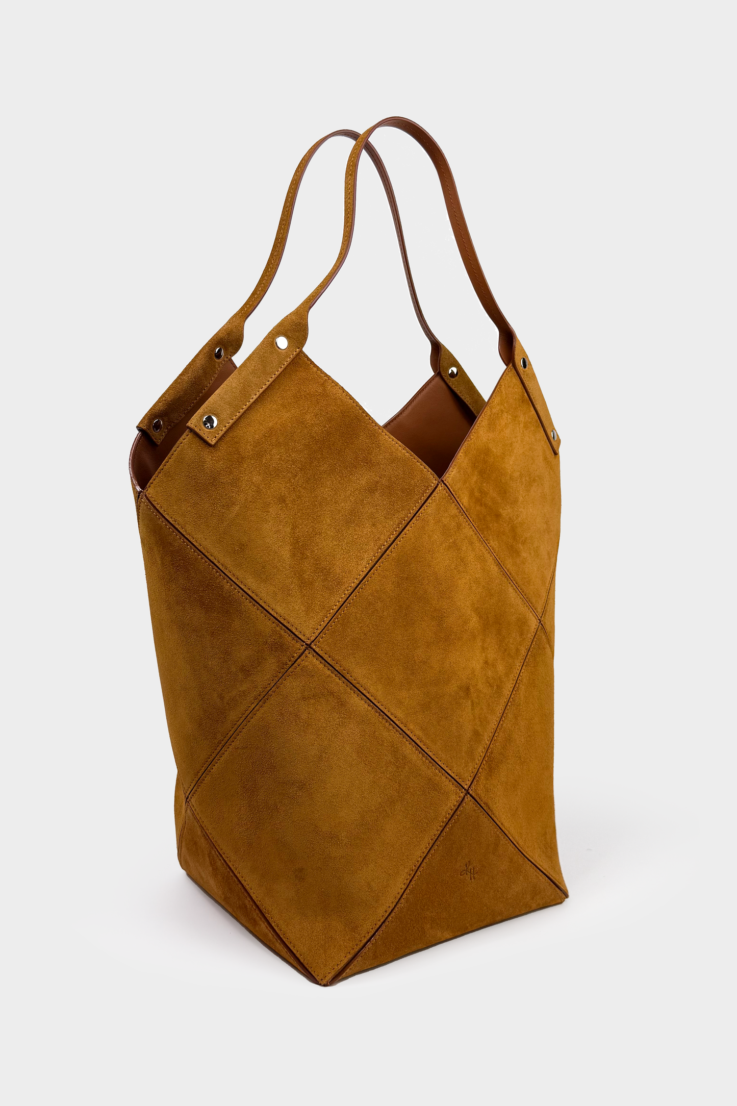 Brown leather bag with geometric design on a white background