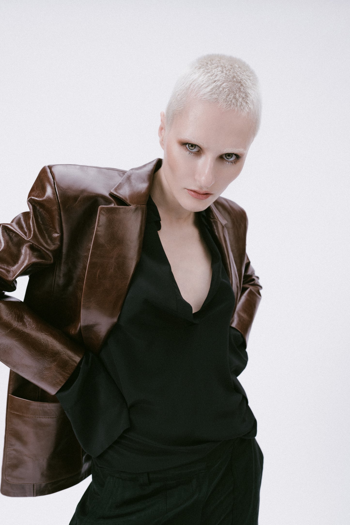 brown leather blazer with black shirt