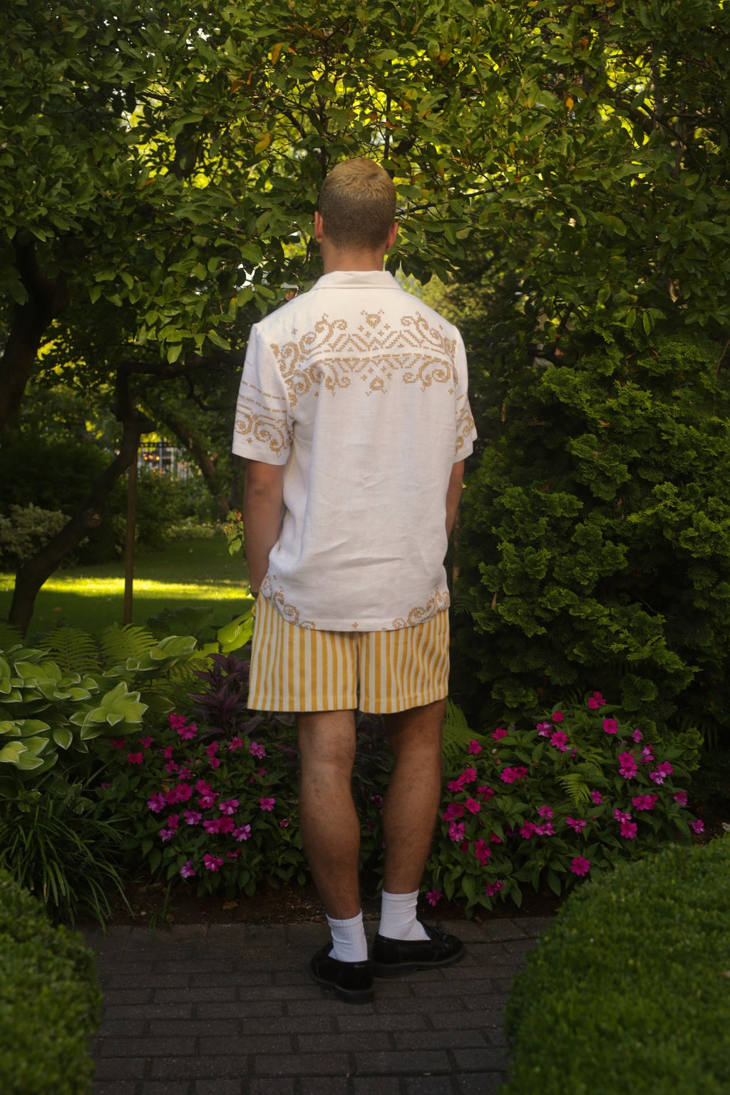 Sam wears the Summer Short in ochre woven stripe