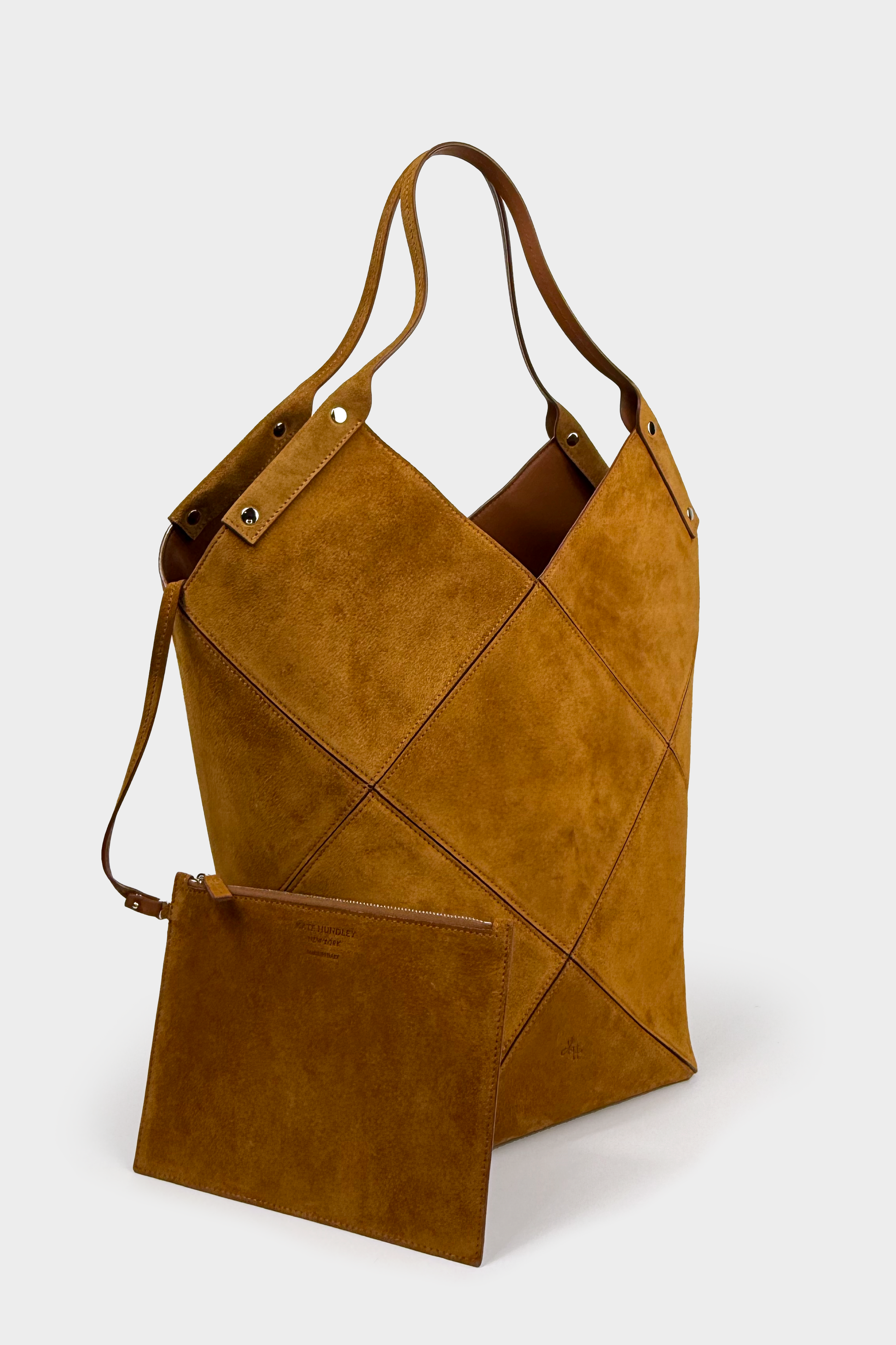 Brown leather tote bag with a geometric design on a white background