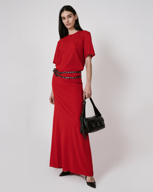 red shirt and skirt black bag standing