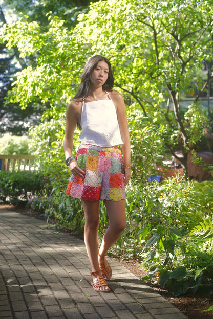 model wears linen top with embroidery