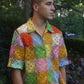 model wears a rainbow crochet button down shirt