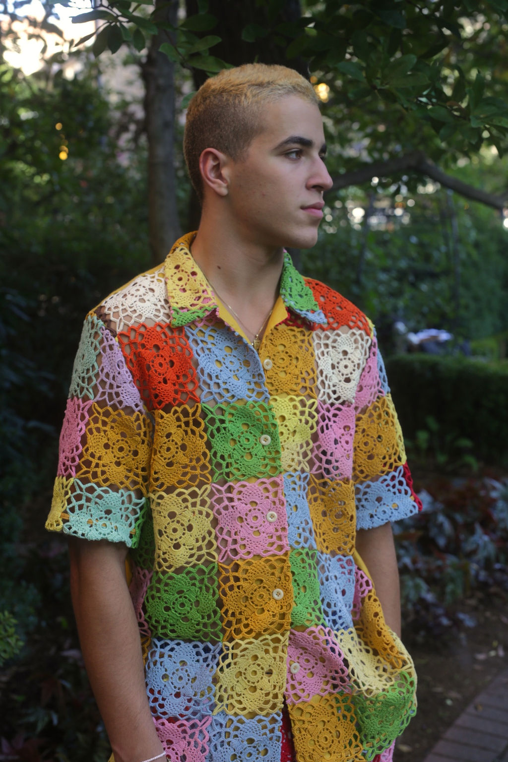 model wears a rainbow crochet button down shirt