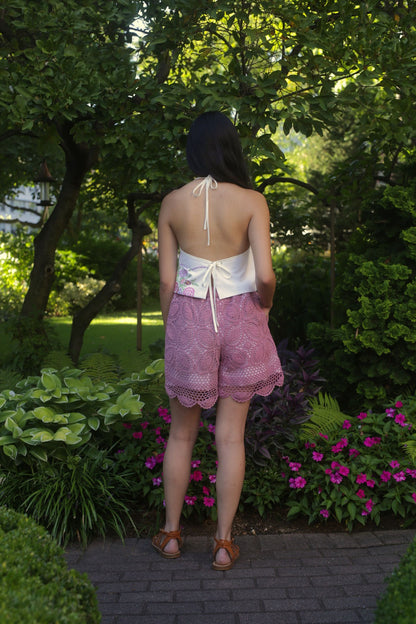 model wears floral embroidered top