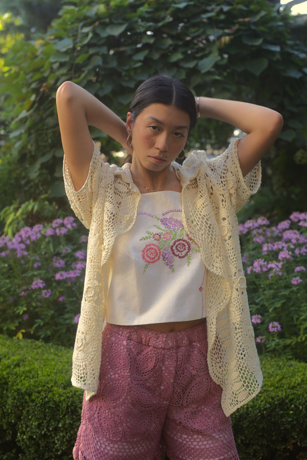 model wears floral embroidered top